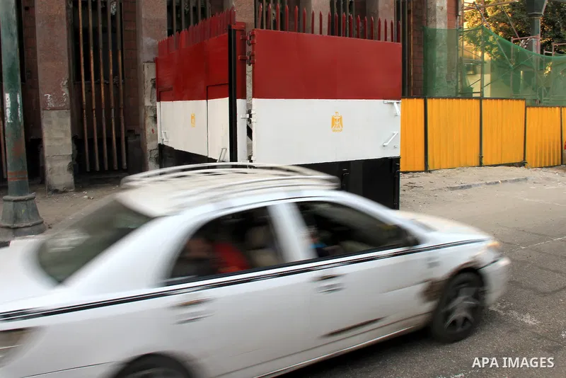 A car is driven past a gate at Al-Qasr Al-Aini street in downtown Cairo, February 10, 2014. A concrete wall blocking Qasr Al-Aini street which set to prevent protesters or rioters entering streets leading to the nearby i...