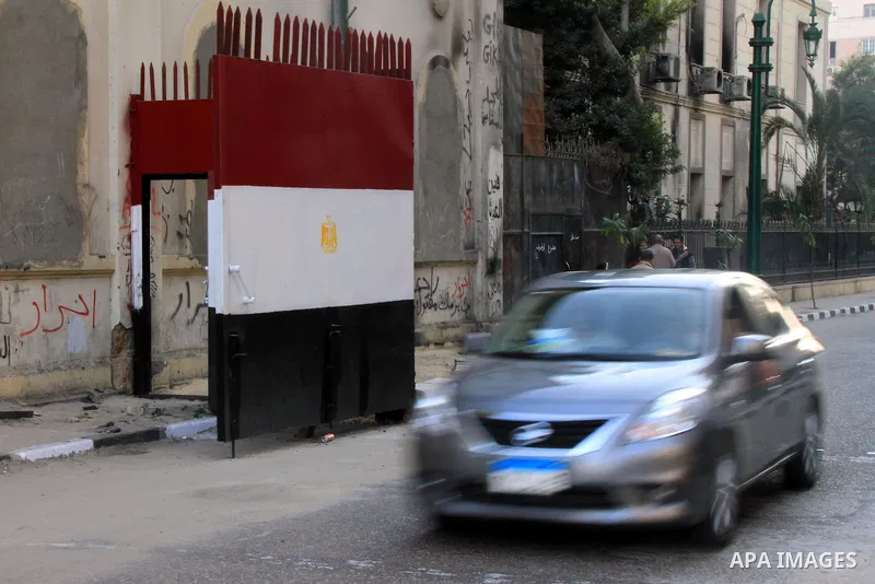 A car is driven past a gate at Al-Qasr Al-Aini street in downtown Cairo, February 10, 2014. A concrete wall blocking Qasr Al-Aini street which set to prevent protesters or rioters entering streets leading to the nearby i...