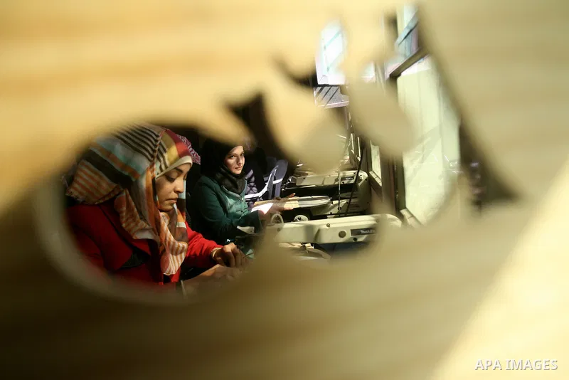 Deaf Palestinian women work on embroidery at al-Amal rehabilitation society, in Rafah in the southern Gaza Strip, February 10, 2014. The society aims to aims to create a social qualitative gathering for deaf to support t...