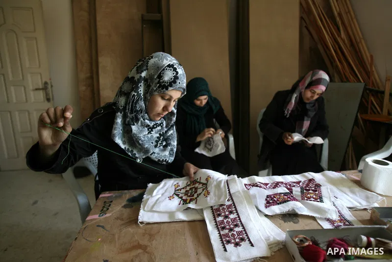 Deaf Palestinian women work on embroidery at al-Amal rehabilitation society, in Rafah in the southern Gaza Strip, February 10, 2014. The society aims to aims to create a social qualitative gathering for deaf to support t...