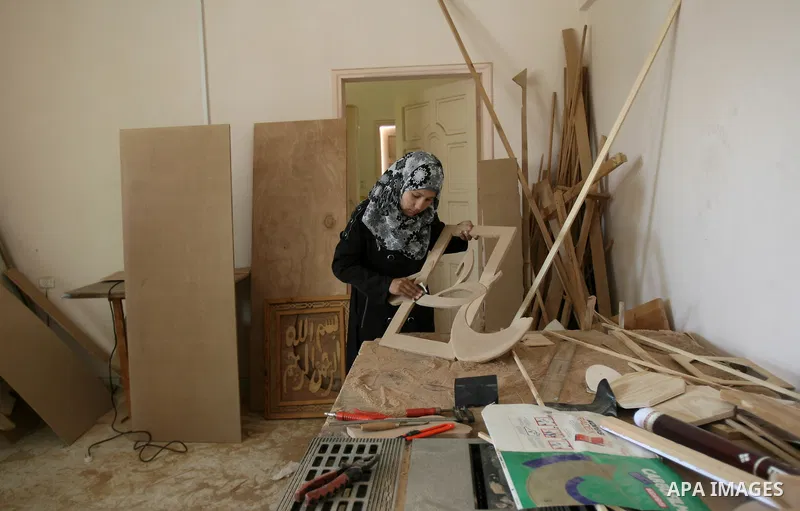 A deaf Palestinian woman works in a carpentry workshop at al-Amal rehabilitation society, in Rafah in the southern Gaza Strip, February 10, 2014. The society aims to aims to create a social qualitative gathering for deaf...