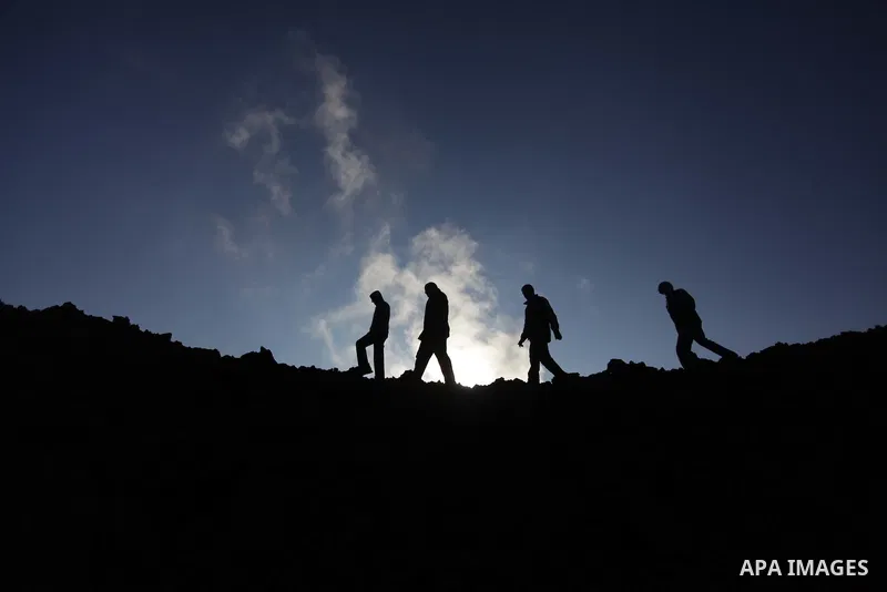Palestinians inspect the scene of what witnesses said was hit by an Israeli air strike at Nusseirat in the centre of the Gaza Strip February 11, 2014. Photo by Ashraf Amra