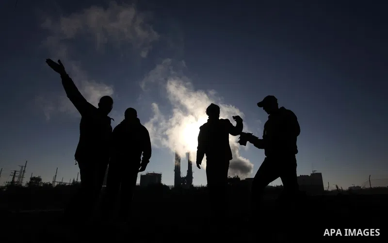Palestinians inspect the scene of what witnesses said was hit by an Israeli air strike at Nusseirat in the centre of the Gaza Strip February 11, 2014. Photo by Ashraf Amra