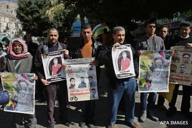Palestinians take part in a protest demanding the release of their relatives prisoners held in Israeli jails, in the west Bank city of Nablus, on Feb. 11, 2014. Photo by Nedal Eshtayah