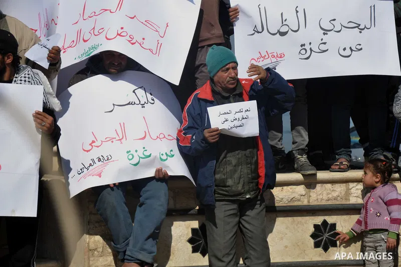 Palestinian fishermen hold banners during a protest against the blockade on Gaza Strip, at the seaport of Gaza City Feb. 12, 2014. Israel imposed a blockade on Gaza in 2007 after its enemy, Islamist group Hamas, seized c...