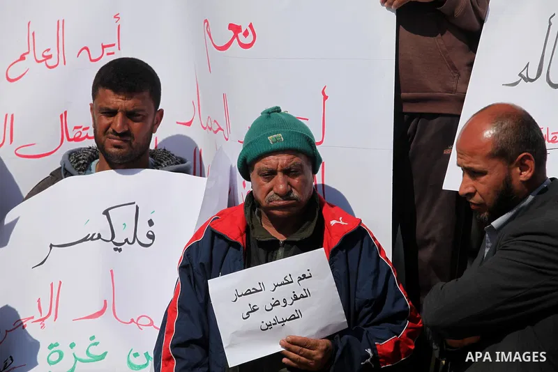 Palestinian fishermen hold banners during a protest against the blockade on Gaza Strip, at the seaport of Gaza City Feb. 12, 2014. Israel imposed a blockade on Gaza in 2007 after its enemy, Islamist group Hamas, seized c...
