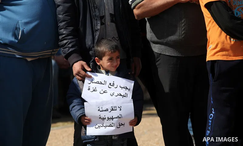 Palestinian fishermen hold banners during a protest against the blockade on Gaza Strip, at the seaport of Gaza City Feb. 12, 2014. Israel imposed a blockade on Gaza in 2007 after its enemy, Islamist group Hamas, seized c...