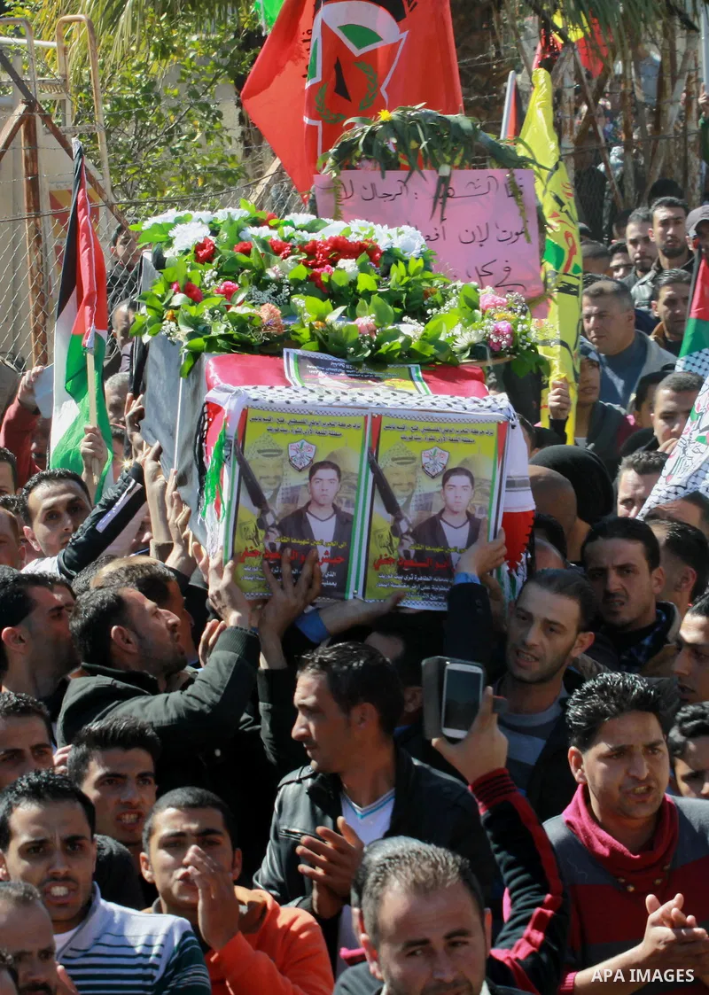 Palestinians carry the coffin of Habash Hanani, killed in 2002, during his funeral in the West Bank city of Nablus. Wednesday, Feb. 12, 2014. Israel started transferring the bodies of 36 Palestinians killed in attacks on...
