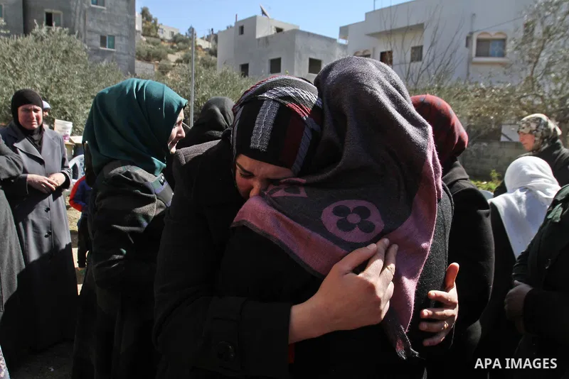 Palestinian relatives mourn on the body of Habash Hanani, killed in 2002, during his funeral in the West Bank city of Nablus. Wednesday, Feb. 12, 2014. Israel started transferring the bodies of 36 Palestinians killed in...