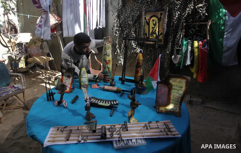 Palestinian Mohammed al-Zomar, 32 works on the remains of Israeli ammunition at his studio in the central Gaza Strip February 12, 2014. Al-Zomar draws and paints on remains of Israeli ammunition that he collected during...