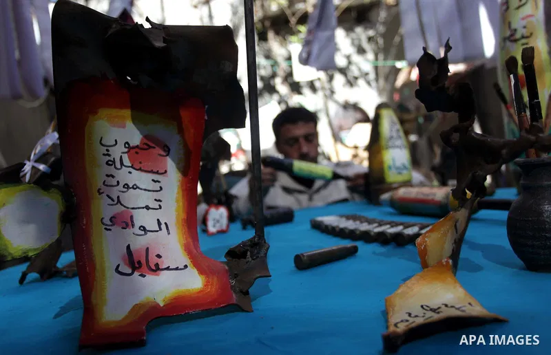 Palestinian Mohammed al-Zomar, 32, displays the remains of Israeli ammunition at his studio in the central Gaza Strip February 12, 2014. Al-Zomar draws and paints on remains of Israeli ammunition that he collected during...