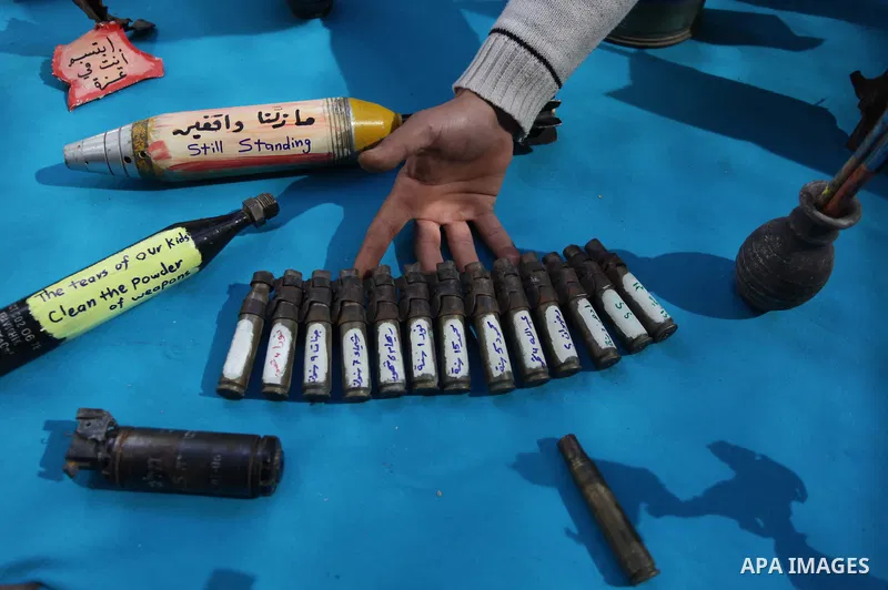 Palestinian Mohammed al-Zomar, 32, displays the remains of Israeli ammunition at his studio in the central Gaza Strip February 12, 2014. Al-Zomar draws and paints on remains of Israeli ammunition that he collected during...