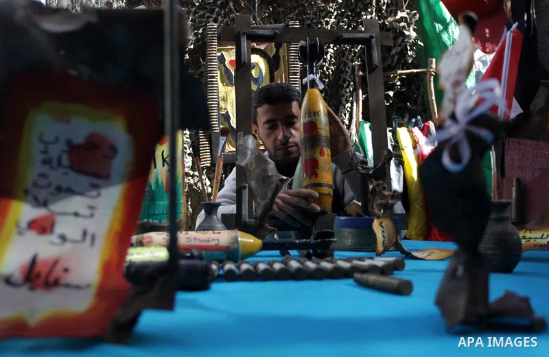 Palestinian Mohammed al-Zomar, 32, displays the remains of Israeli ammunition at his studio in the central Gaza Strip February 12, 2014. Al-Zomar draws and paints on remains of Israeli ammunition that he collected during...