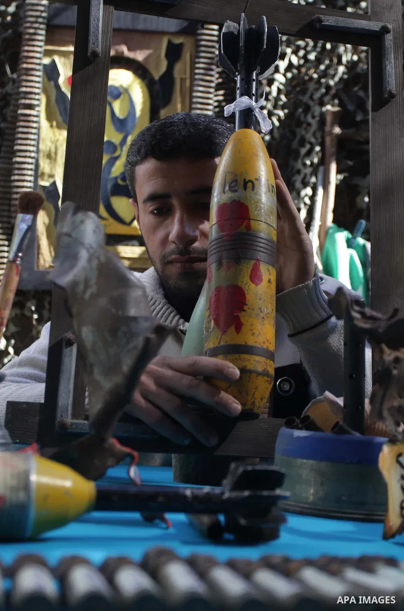 Palestinian Mohammed al-Zomar, 32, displays the remains of Israeli ammunition at his studio in the central Gaza Strip February 12, 2014. Al-Zomar draws and paints on remains of Israeli ammunition that he collected during...