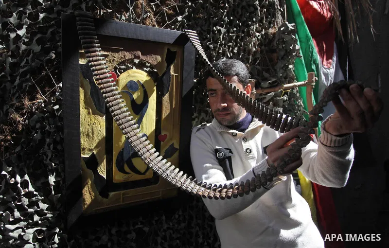 Palestinian Mohammed al-Zomar, 32, displays the remains of Israeli ammunition at his studio in the central Gaza Strip February 12, 2014. Al-Zomar draws and paints on remains of Israeli ammunition that he collected during...