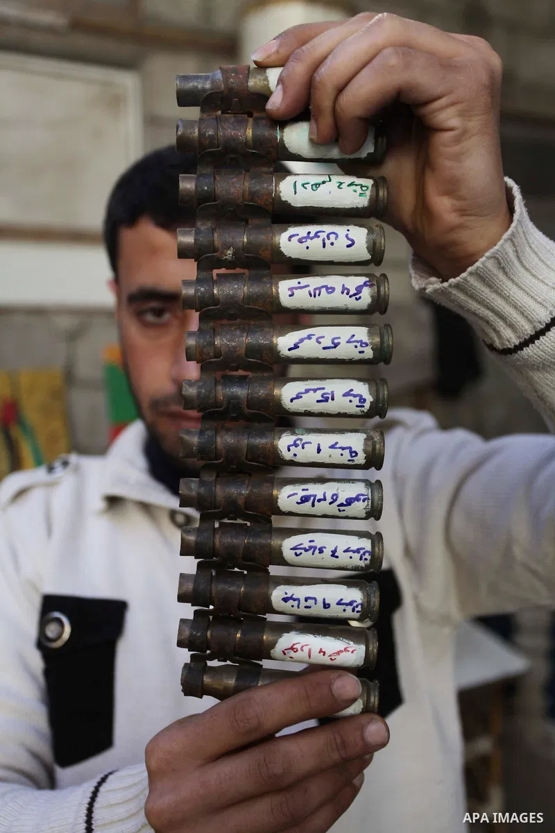 Palestinian Mohammed al-Zomar, 32, displays the remains of Israeli ammunition at his studio in the central Gaza Strip February 12, 2014. Al-Zomar draws and paints on remains of Israeli ammunition that he collected during...