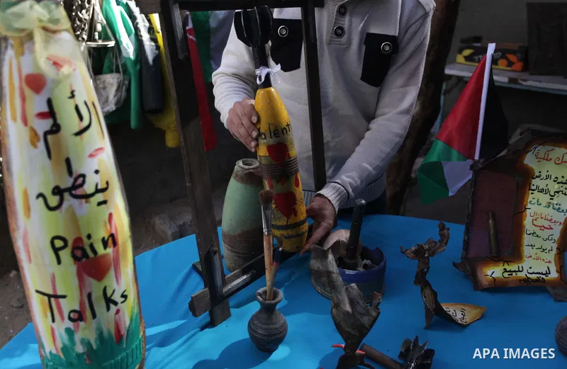 Palestinian Mohammed al-Zomar, 32, displays the remains of Israeli ammunition at his studio in the central Gaza Strip February 12, 2014. Al-Zomar draws and paints on remains of Israeli ammunition that he collected during...