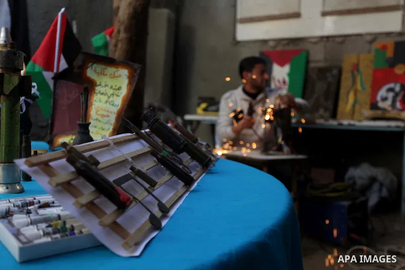 Palestinian Mohammed al-Zomar, 32 works on the remains of Israeli ammunition at his studio in the central Gaza Strip February 12, 2014. Al-Zomar draws and paints on remains of Israeli ammunition that he collected during...