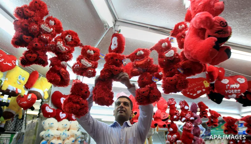 A Palestinian vendor displays gifts at his store ahead of Valentine's day in the West Bank City of Ramallah on February 12, 2014. Valentine's Day is increasingly popular among younger Palestinians, many of whom have take...