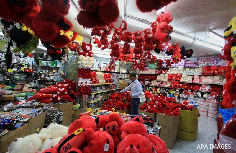 A Palestinian vendor displays gifts at his store ahead of Valentine's day in the West Bank City of Ramallah on February 12, 2014. Valentine's Day is increasingly popular among younger Palestinians, many of whom have take...