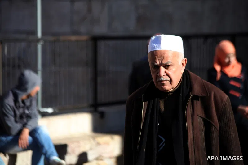 Palestinian walk in front of Damascus gater in Jerusalem's Old City on February 12, 2014. Minister of Holy Places for the PA Mahmoud al-Habbash told Israel's Channel 10 network that the PA wants control of all the areas...