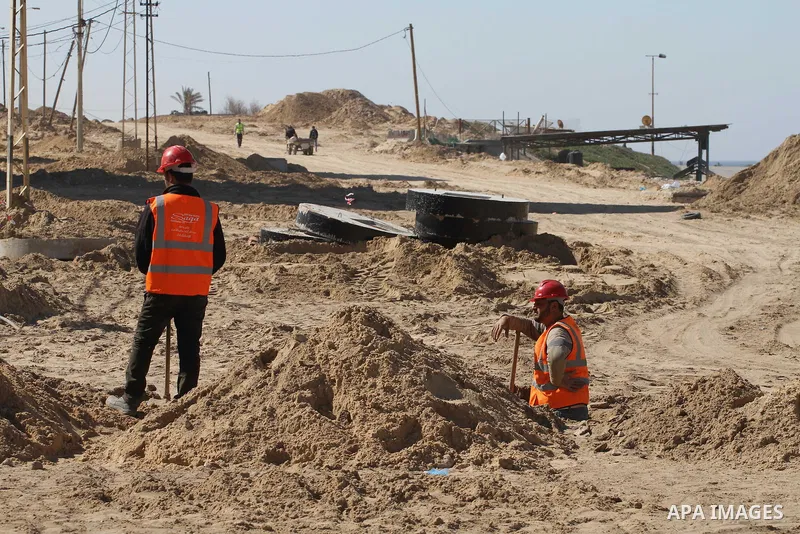 Palestinian workers repair and reconstruction of roads founded by Qatari grant projects in Gaza city, in Feb. 13, 2014. Photo by Mohammed Asad