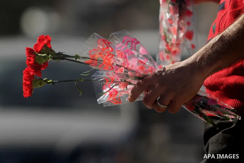 A Palestinian vendor sells a flowers ahead of Valentine's day at streets in the West Bank city of Ramallah, on Feb. 13, 2014. Valentine's Day is increasingly popular among younger Palestinians, many of whom have taken up...