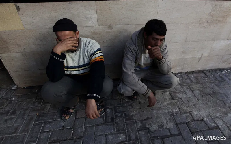 Palestinian relatives of Ibrahim Suleiman Mansour, 26, react after he dead by Israeli security forces at a hospital in Gaza City on February 13, 2014. A Palestinian man was moderately injured Thursday and another died fr...