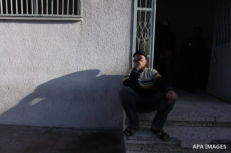 A Palestinian relative of Ibrahim Suleiman Mansour, 26, reacts after he dead by Israeli security forces at a hospital in Gaza City on February 13, 2014. A Palestinian man was moderately injured Thursday and another died...