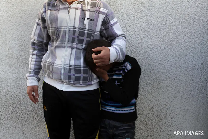 Palestinian relatives of Ibrahim Suleiman Mansour, 26, react after he dead by Israeli security forces at a hospital in Gaza City on February 13, 2014. A Palestinian man was moderately injured Thursday and another died fr...