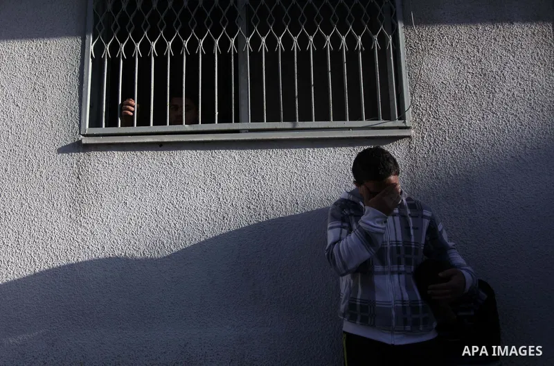 Palestinian relatives of Ibrahim Suleiman Mansour, 26, react after he dead by Israeli security forces at a hospital in Gaza City on February 13, 2014. A Palestinian man was moderately injured Thursday and another died fr...