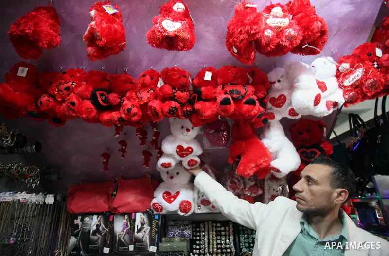 A Palestinian vendor displays gift at his store ahead of Valentine's day in Jerusalem on February 13, 2014. Valentine's Day is increasingly popular among younger Palestinians, many of whom have taken up the custom of giv...
