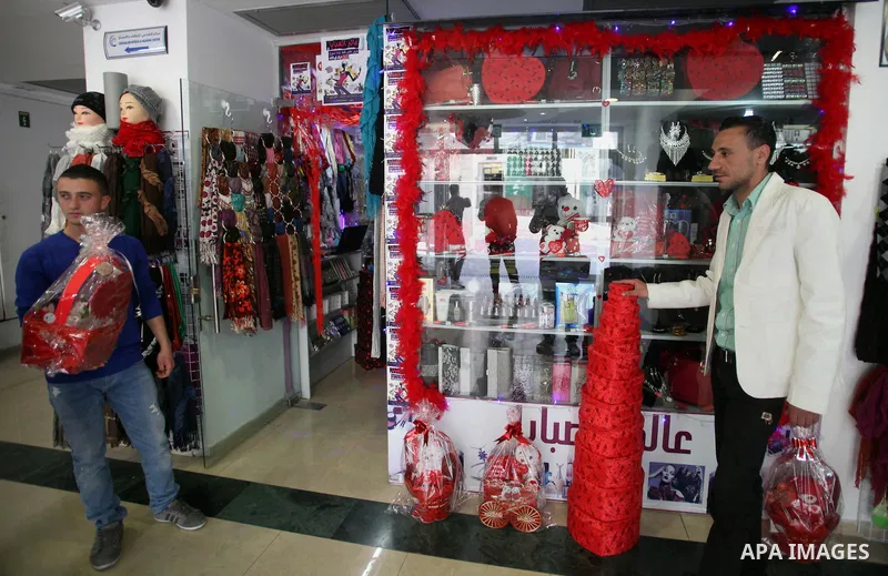 A Palestinian vendor displays gift at his store ahead of Valentine's day in Jerusalem on February 13, 2014. Valentine's Day is increasingly popular among younger Palestinians, many of whom have taken up the custom of giv...