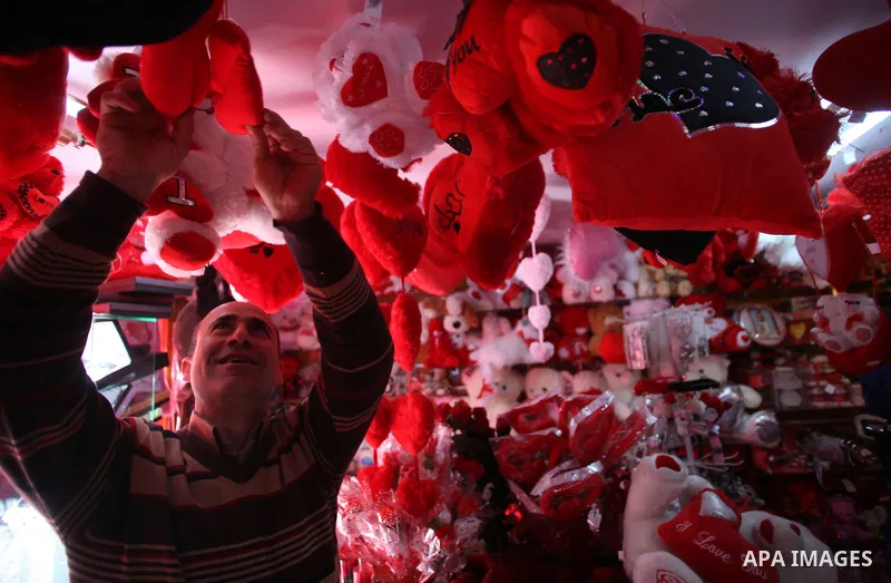 A Palestinian vendor displays gift at his store ahead of Valentine's day in Jerusalem on February 13, 2014. Valentine's Day is increasingly popular among younger Palestinians, many of whom have taken up the custom of giv...