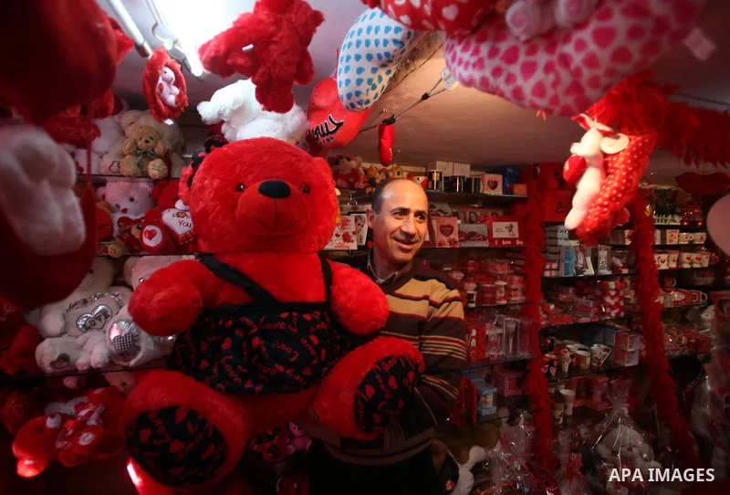 A Palestinian vendor displays gift at his store ahead of Valentine's day in Jerusalem on February 13, 2014. Valentine's Day is increasingly popular among younger Palestinians, many of whom have taken up the custom of giv...