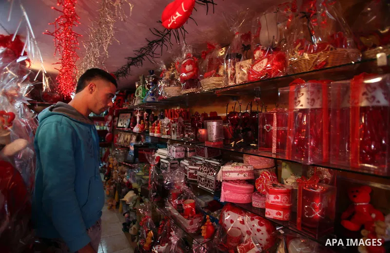 A Palestinian vendor displays gift at his store ahead of Valentine's day in Jerusalem on February 13, 2014. Valentine's Day is increasingly popular among younger Palestinians, many of whom have taken up the custom of giv...