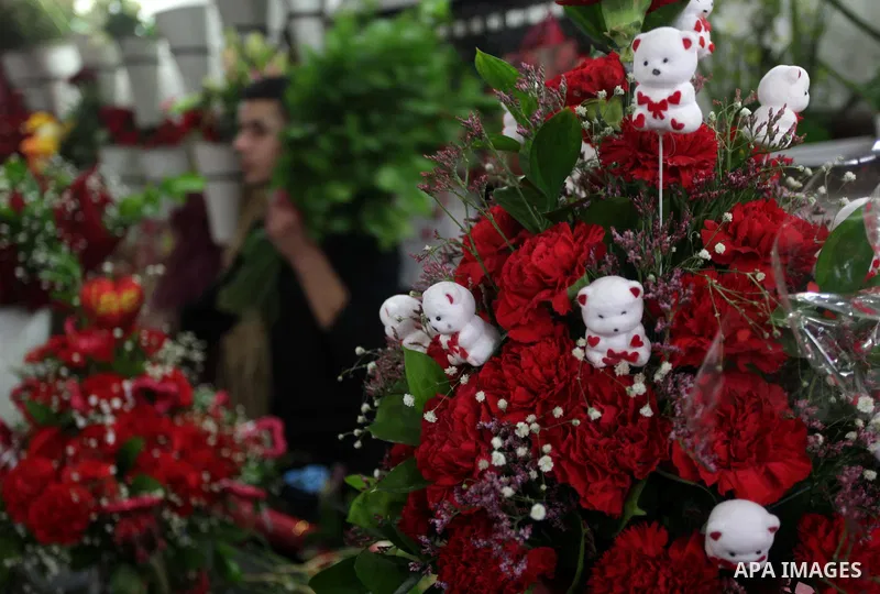 A Palestinian vendor displays roses at his gift store ahead of Valentine's day in Gaza City on February 13, 2014. Valentine's Day is increasingly popular among younger Palestinians, many of whom have taken up the custom...