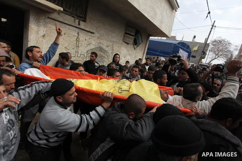 Palestinians carry the body of Ibrahim Mansour, 26, who was killed by Israeli soldiers, during his funeral in Gaza City February 14, 2014. Israeli soldiers shot and killed Mansour and wounded another on Thursday in the G...