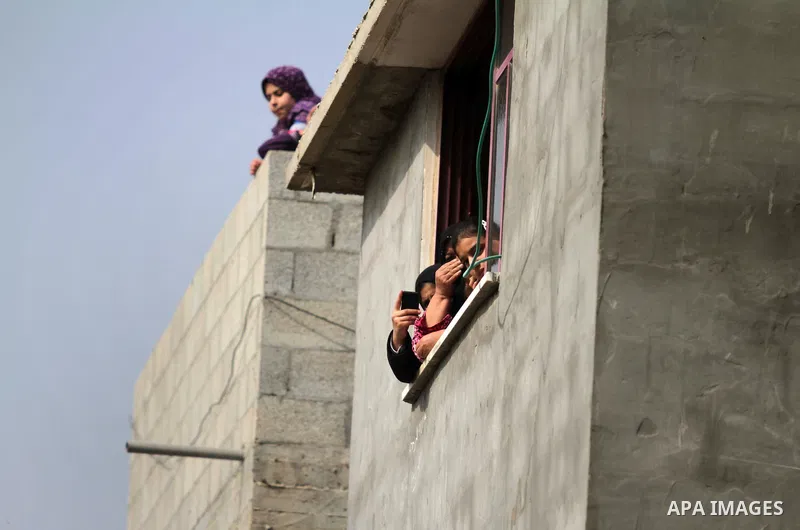 Palestinians look on during the funeral of Ibrahim Mansour, 26, who was killed by Israeli soldiers, in Gaza City February 14, 2014. Israeli soldiers shot and killed Mansour and wounded another on Thursday in the Gaza Str...