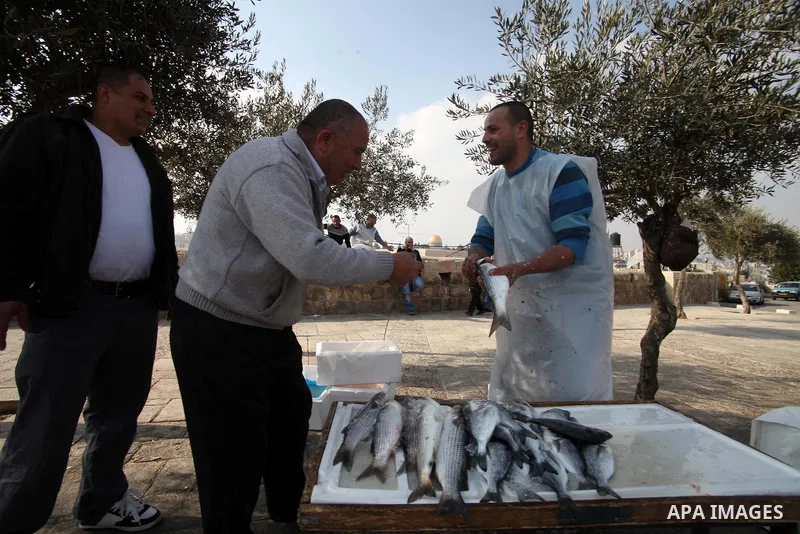 A Palestinian man sells fish outside the Al-Aqsa compound, Islam's third holiest site, following Friday prayers in the old city of Jerusalem February 14, 2014. Photo by Saeed Qaq