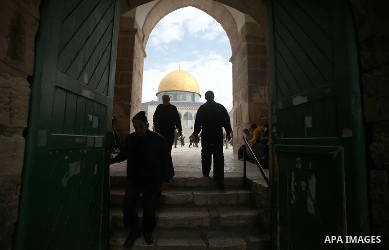 Palestinian worshipers walk in front of the Dome of the rock mosque at the Al-Aqsa compound, Islam's third holiest site, following Friday prayers in the old city of Jerusalem February 14, 2014. Photo by Saeed Qaq