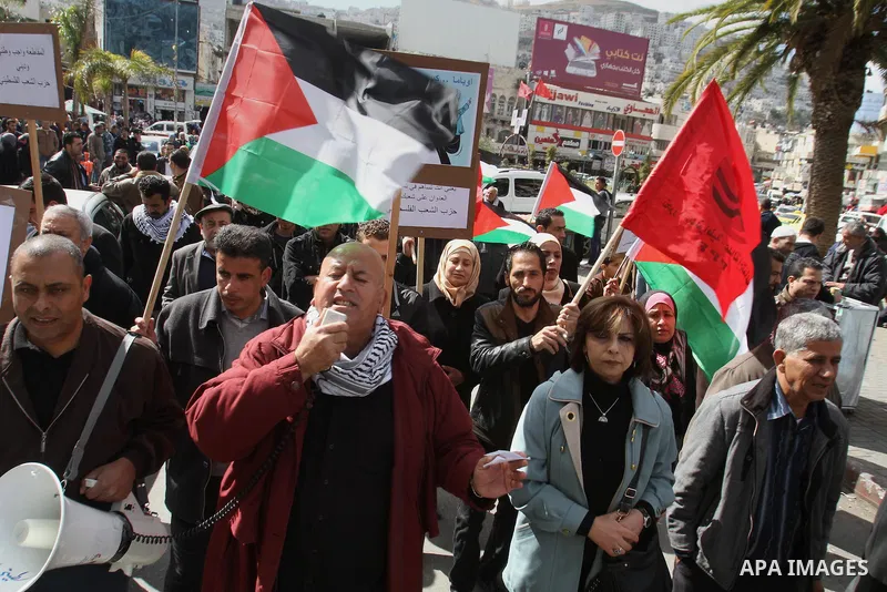 Members of Palestinian People's Party chant during a protest to demand the boycott of Israeli goods in the West bank city of Nablus, on Feb. 15 , 2014. Photo by Nedal Eshtayah
