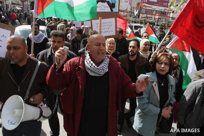 Members of Palestinian People's Party chant during a protest to demand the boycott of Israeli goods in the West bank city of Nablus, on Feb. 15 , 2014. Photo by Nedal Eshtayah