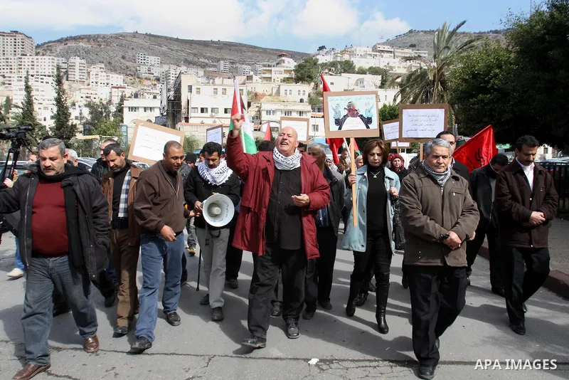 Members of Palestinian People's Party chant during a protest to demand the boycott of Israeli goods in the West bank city of Nablus, on Feb. 15 , 2014. Photo by Nedal Eshtayah