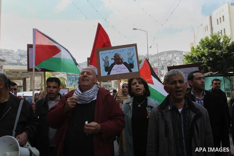 Members of Palestinian People's Party chant during a protest to demand the boycott of Israeli goods in the West bank city of Nablus, on Feb. 15 , 2014. Photo by Nedal Eshtayah
