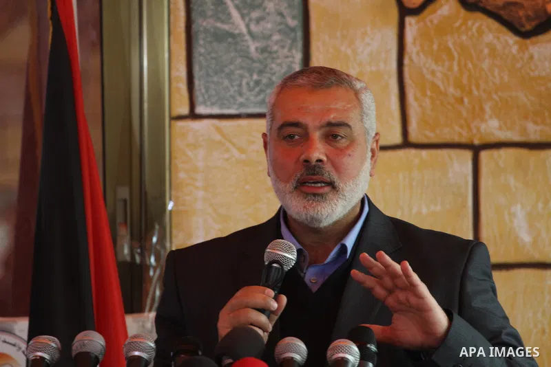 Palestinian Prime Minister in Gaza strip, Ismail Haniyeh speaks during the opening ceremony of freed Palestinian female prisoners association, in Gaza city, on Feb. 15, 2014. Photo by Mohammed Asad