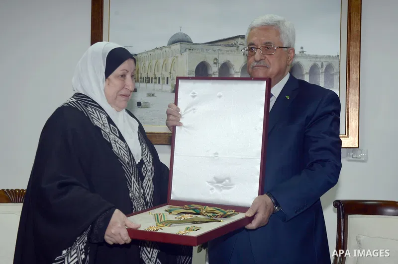 Palestinian President, Mahmoud Abbas (Abu Mazen), honors the family of the martyr Abu Ali Iyad in the West Bank city of Ramallah, on Feb. 15, 2014. Photo by Thaer Ganaim
