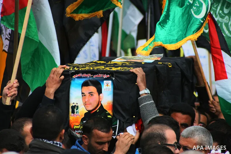 Palestinian security forces carry a coffin containing the remains of Mohammed Shaheen, during a funeral in the West Bank village of Dura, southeast of Hebron, Feb. 10, 2014. Israel on Sunday evening delivered the remains...