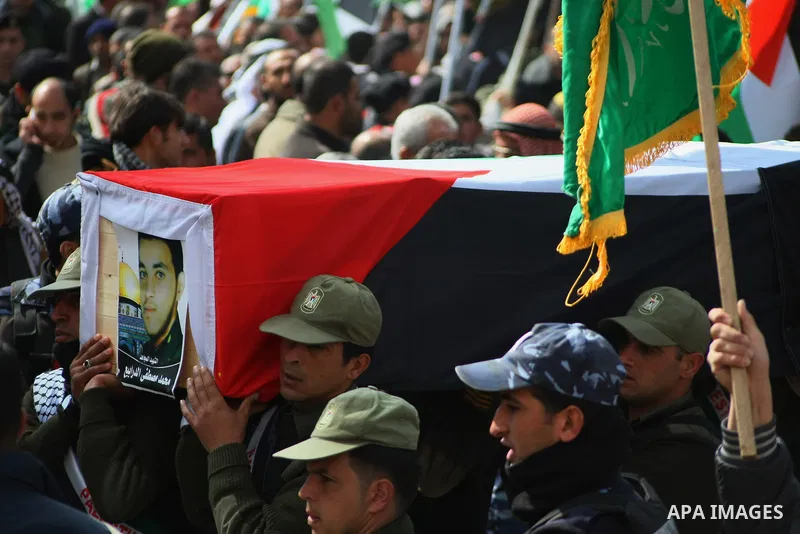 Palestinian security forces carry a coffin containing the remains of Mohammed Shaheen, during a funeral in the West Bank village of Dura, southeast of Hebron, Feb. 10, 2014. Israel on Sunday evening delivered the remains...