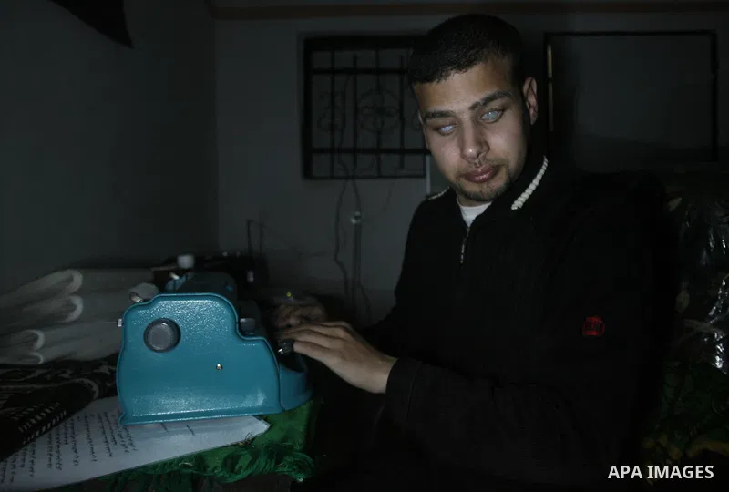 Palestinian Mahmoud Juhaish, 23, a blind youth studies at his house in Rafah refugee camp in southern Gaza strip on Feb. 17, 2014. Juhaish studies at the Islamic University in Gaza City as he suffers blindness, after his...